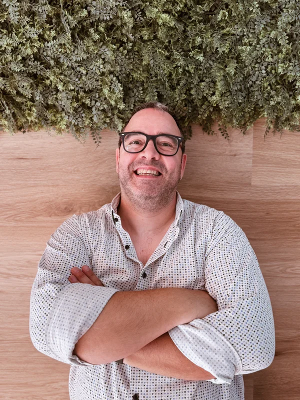 Gioacchino Poletto smiling with his arms crossed
